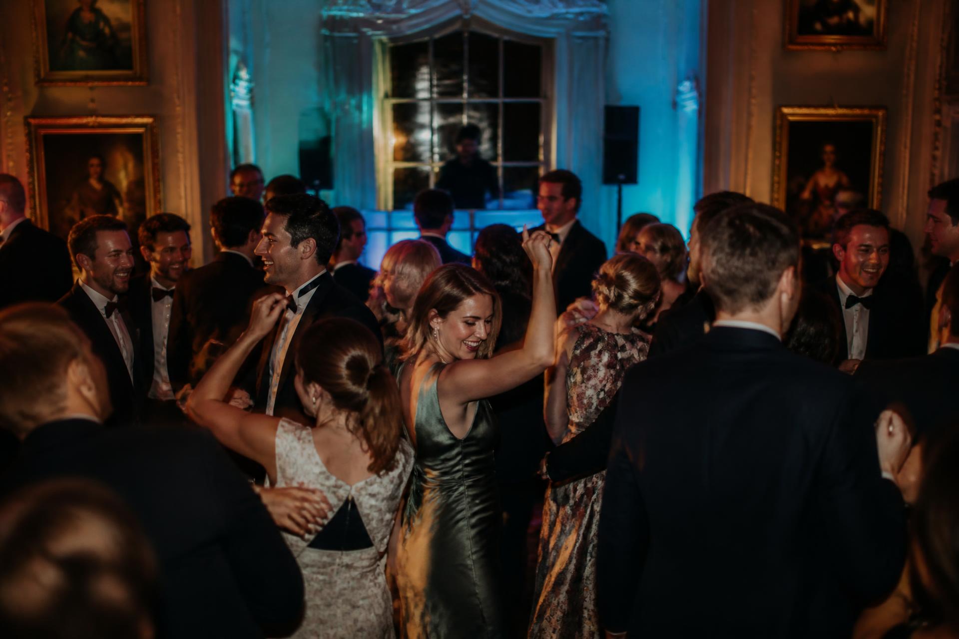 Guests filling the dancefloor at an evening wedding reception